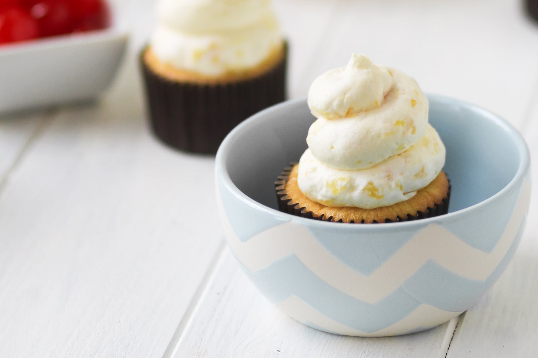 https://food-fanatic-res.cloudinary.com/iu/s--0O82U7_K--/f_auto,q_auto/v1439926620/pineapple-whip-cupcakes-photo