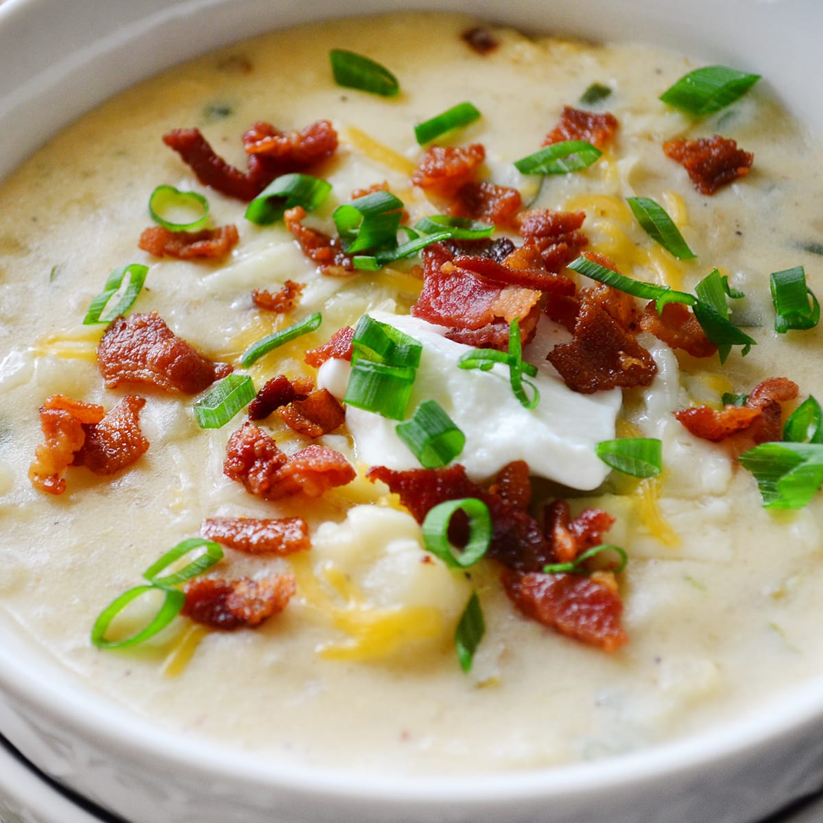 https://food-fanatic-res.cloudinary.com/iu/s--6sSOn62f--/c_thumb,f_auto,g_auto,h_1200,q_auto,w_1200/v1483736472/baked-potato-soup-photo