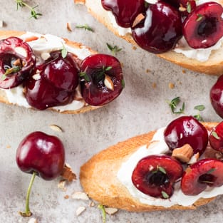 Cherry goat cheese crostini with thyme and almonds photo