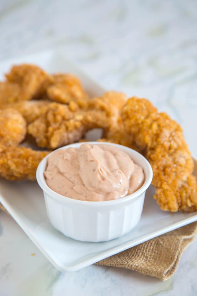 Nostalgic corn dog with Cane's Sauce at Raising Cane's.