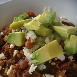 Chili con carne with avocado cotija cheese and minced onion