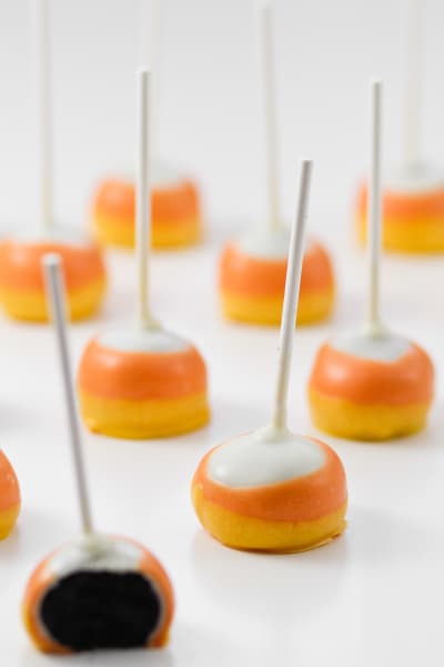 Candy Corn Oreo Pops are a simple no-bake treat that are a hit with any crowd. Super easy to make with perfect Candy Corn layers!