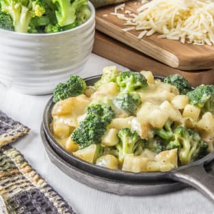 Healthy cheesy skillet potatoes with broccoli photo