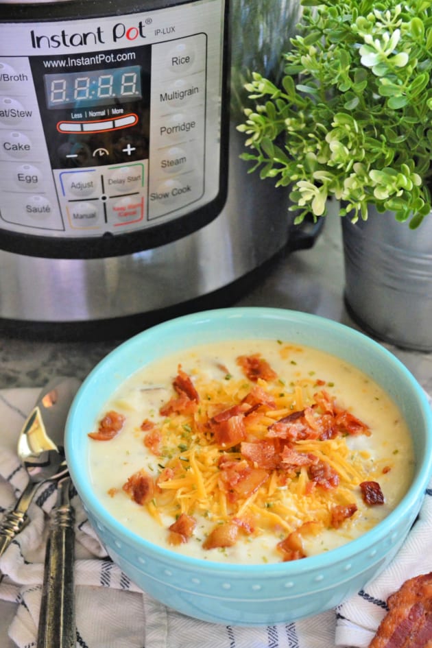 Instant Pot Loaded Baked Potato Soup in a ceramic bowl with toppings