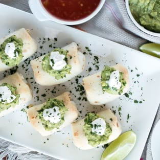 Baked mini chimichangas with creamy spicy guacamole photo